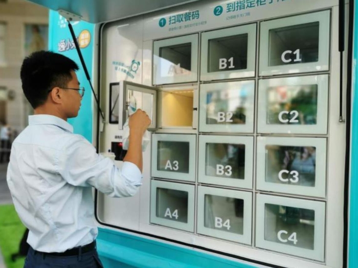 一位顧客正從智能保溫柜取走自己的早餐。新華網(wǎng)發(fā)（熊多多 攝）