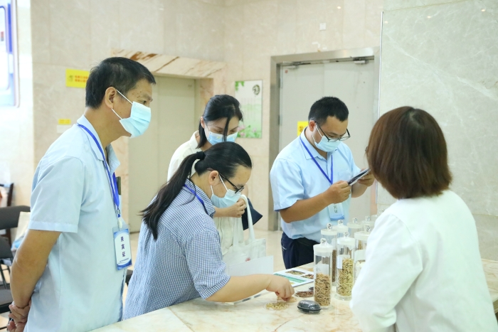 圖為工作人員向市民代表講解中藥材（枸杞、菊花等）真?zhèn)舞b別知識(shí)。