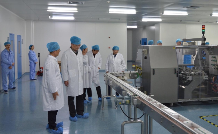 圖為調(diào)研組實地查看一家生物制藥企業(yè)生產(chǎn)車間，了解企業(yè)需求。