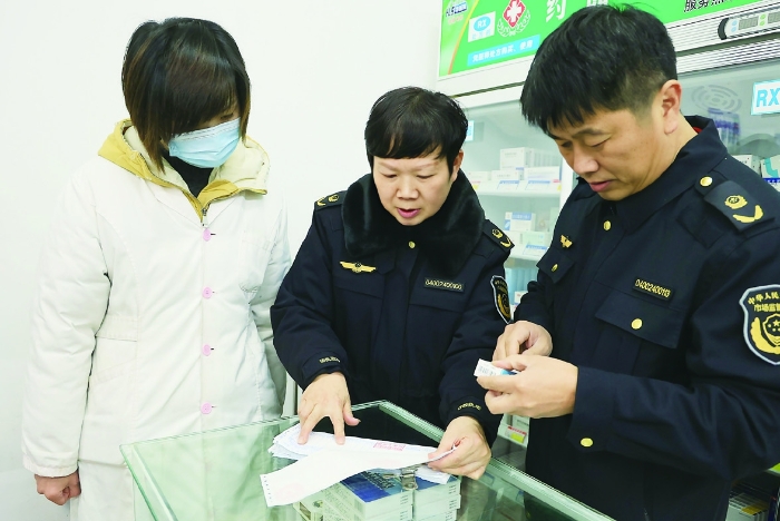 圖②為2024年1月30日，在藥品檢查專項行動中，衡陽市市場監(jiān)管局工作人員正在零售藥店查看臺賬資料。